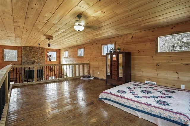 unfurnished bedroom featuring brick wall, lofted ceiling, wooden ceiling, hardwood / wood-style flooring, and wood walls