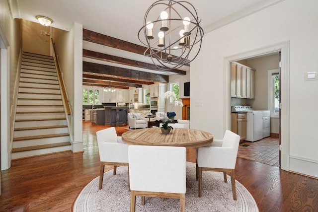 dining area with a chandelier, separate washer and dryer, healthy amount of natural light, stairs, and beamed ceiling