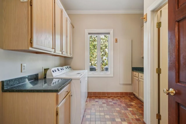 laundry area featuring cabinet space, washing machine and dryer, baseboards, and crown molding