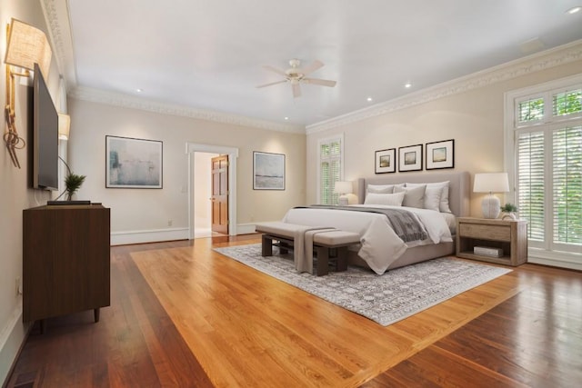bedroom with multiple windows, crown molding, dark wood finished floors, baseboards, and recessed lighting