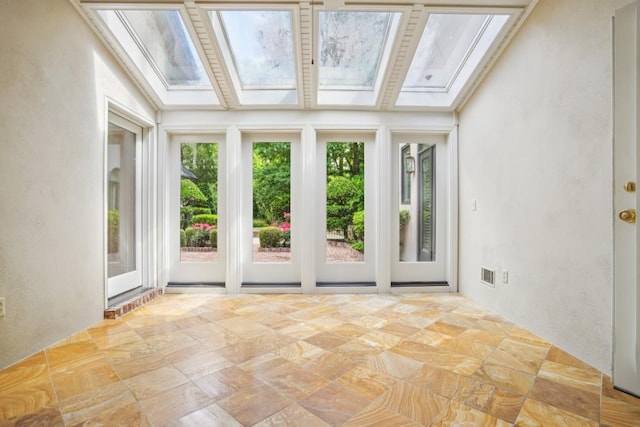 unfurnished sunroom featuring a skylight