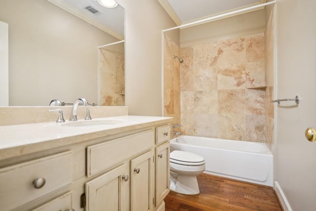 full bath with toilet, bathtub / shower combination, crown molding, wood finished floors, and vanity