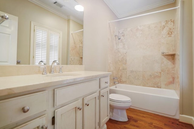 full bath with crown molding, wood finished floors, toilet, vanity, and shower / washtub combination