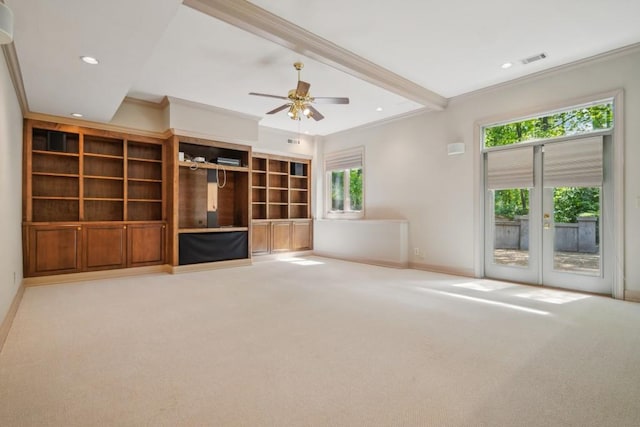 unfurnished living room with crown molding, carpet floors, plenty of natural light, baseboards, and a ceiling fan