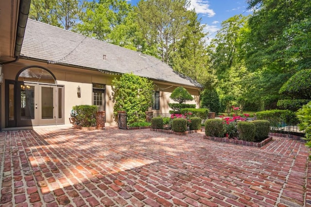 view of patio / terrace with french doors and fence