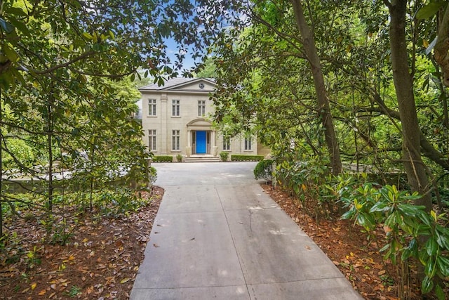 neoclassical home featuring concrete driveway