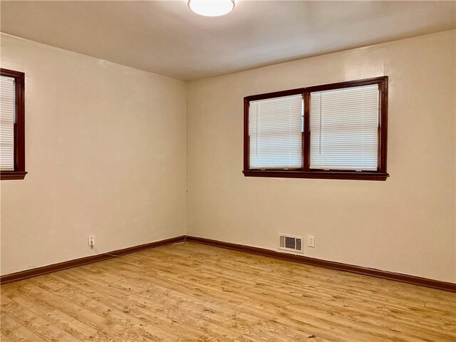 spare room with light wood-type flooring