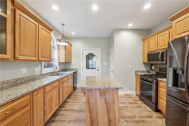 37 Long Branch Way, Dahlonega, GA 30533 - kitchen featuring light wood-style flooring, tasteful backsplash, a kitchen island, appliances with stainless steel finishes, and a sink