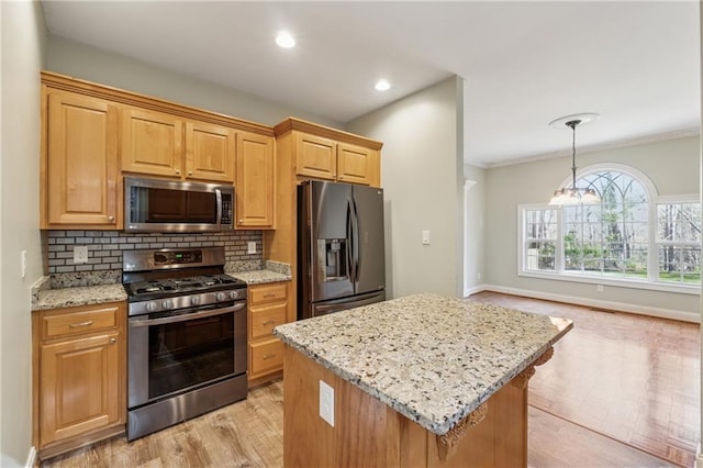 37 Long Branch Way, Dahlonega, GA 30533 - kitchen with light wood-style flooring, a kitchen island, light stone countertops, decorative backsplash, and appliances with stainless steel finishes