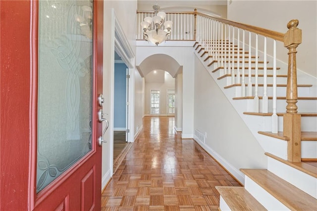37 Long Branch Way, Dahlonega, GA 30533 - foyer entrance with arched walkways, stairway, baseboards, and an inviting chandelier