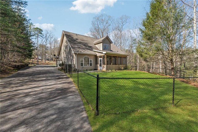 37 Long Branch Way, Dahlonega, GA 30533 - view of front of property featuring a sunroom, driveway, a fenced front yard, and a front lawn