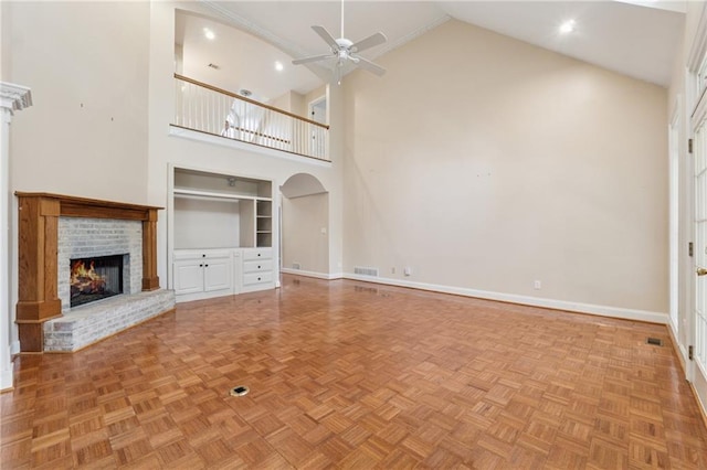 37 Long Branch Way, Dahlonega, GA 30533 - unfurnished living room with high vaulted ceiling, a fireplace, a ceiling fan, baseboards, and built in shelves