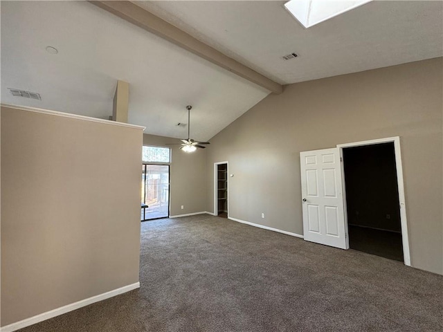 carpeted empty room featuring ceiling fan, a skylight, high vaulted ceiling, and beamed ceiling