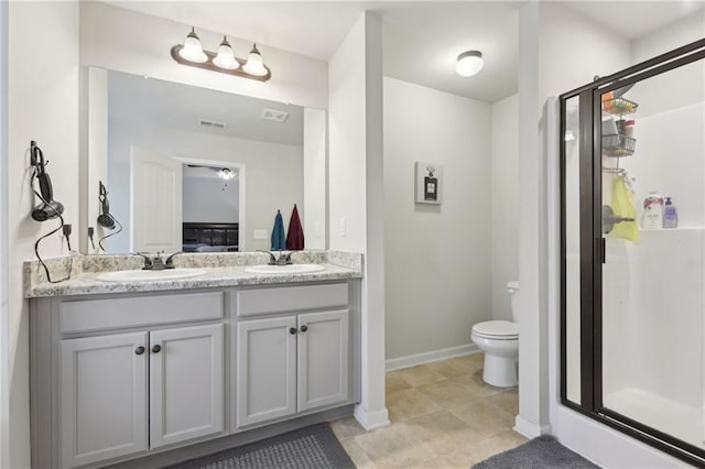 bathroom with toilet, a shower with shower door, and vanity