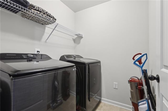 clothes washing area with separate washer and dryer