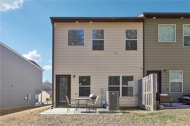 back of property featuring central AC unit and a patio