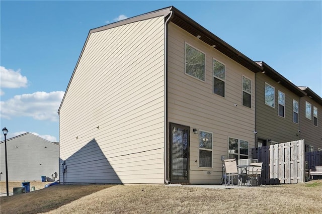 rear view of property with a lawn and a patio area