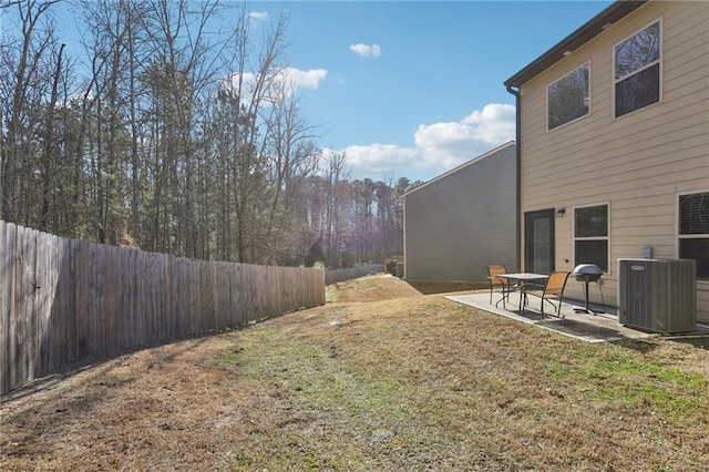 view of yard featuring central AC and a patio