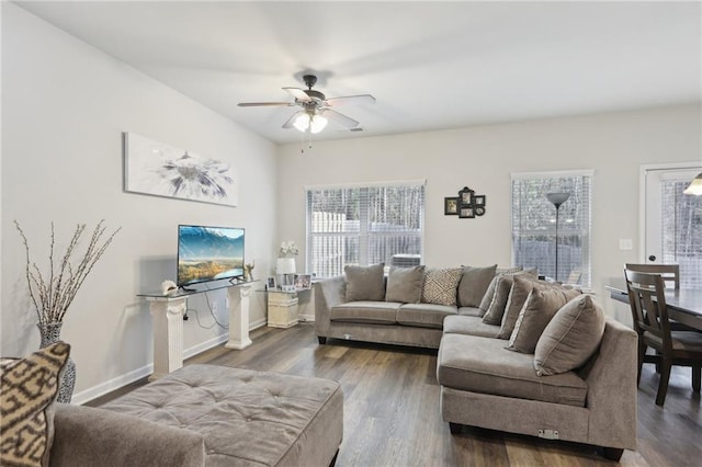 living room with ceiling fan and dark hardwood / wood-style flooring