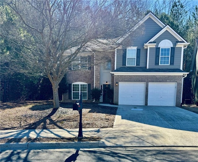 traditional-style home featuring brick siding, concrete driveway, and a garage