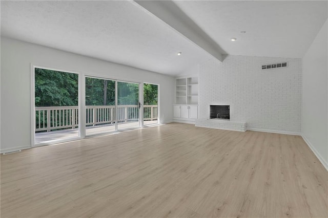 4717 Westhampton Dr, Tucker, GA 30084 - unfurnished living room with light wood-type flooring, a fireplace, baseboards, brick wall, and built in features