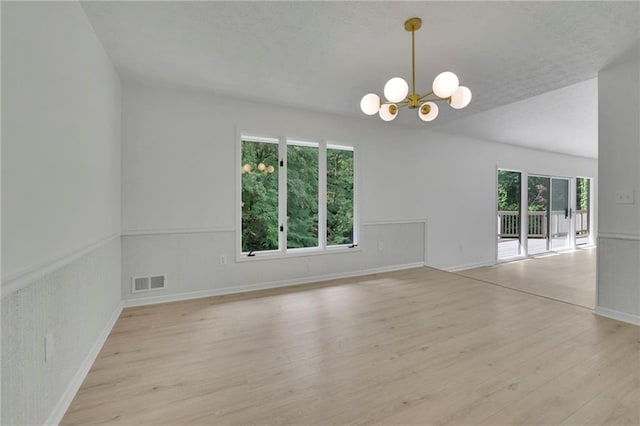4717 Westhampton Dr, Tucker, GA 30084 - unfurnished room featuring a chandelier, light wood-style floors, baseboards, and a textured ceiling