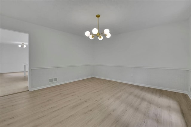 4717 Westhampton Dr, Tucker, GA 30084 - unfurnished room featuring a chandelier, wood finished floors, and baseboards