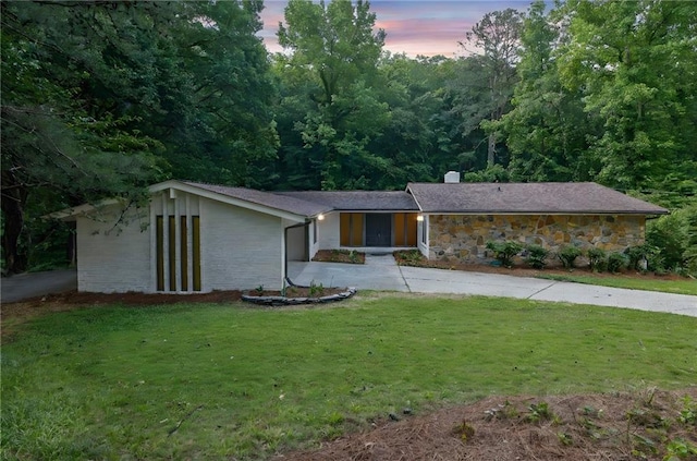 4717 Westhampton Dr, Tucker, GA 30084 - mid-century inspired home with concrete driveway, a lawn, a chimney, a garage, and stone siding