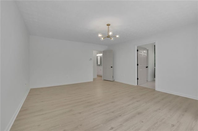 4717 Westhampton Dr, Tucker, GA 30084 - unfurnished room featuring a chandelier, light wood-style flooring, and baseboards
