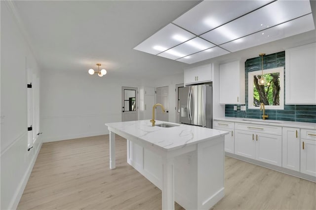4717 Westhampton Dr, Tucker, GA 30084 - kitchen with stainless steel refrigerator with ice dispenser, a sink, light wood-style floors, and white cabinets