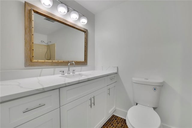 4717 Westhampton Dr, Tucker, GA 30084 - bathroom with vanity, toilet, baseboards, and a shower