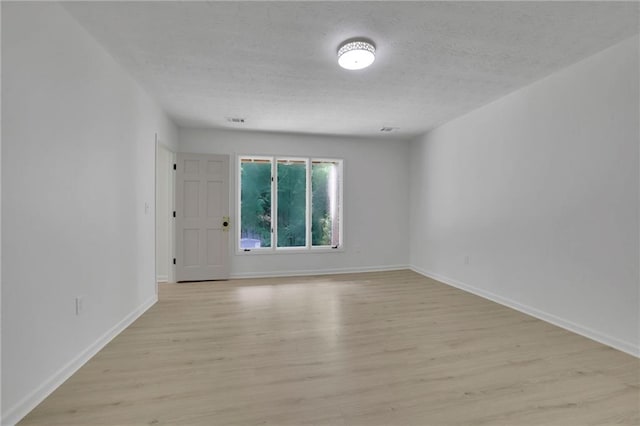 4717 Westhampton Dr, Tucker, GA 30084 - empty room with a textured ceiling, light wood-style flooring, and baseboards