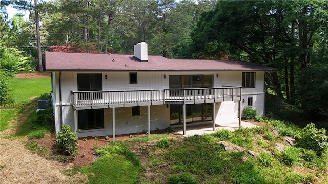 4717 Westhampton Dr, Tucker, GA 30084 - back of house with a chimney, a wooden deck, and a patio