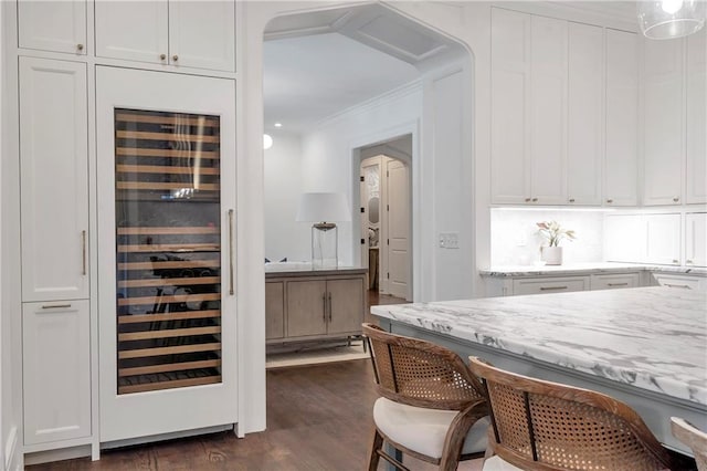 bar featuring dark wood-style floors, beverage cooler, tasteful backsplash, and crown molding