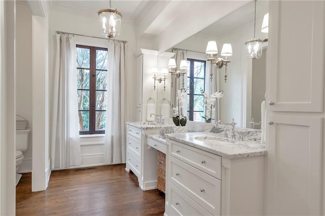 full bath with toilet, wood finished floors, visible vents, vanity, and crown molding