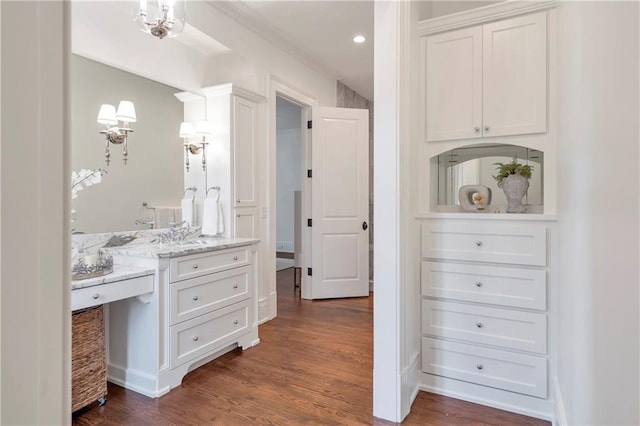 bathroom with wood finished floors and vanity