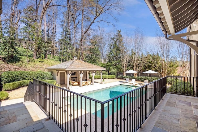 view of pool with a gazebo, fence, a fenced in pool, and a patio