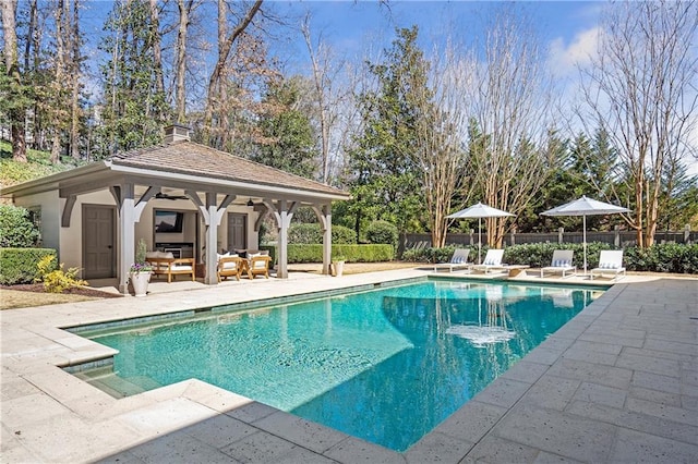 view of pool with ceiling fan, a patio area, fence, and a fenced in pool