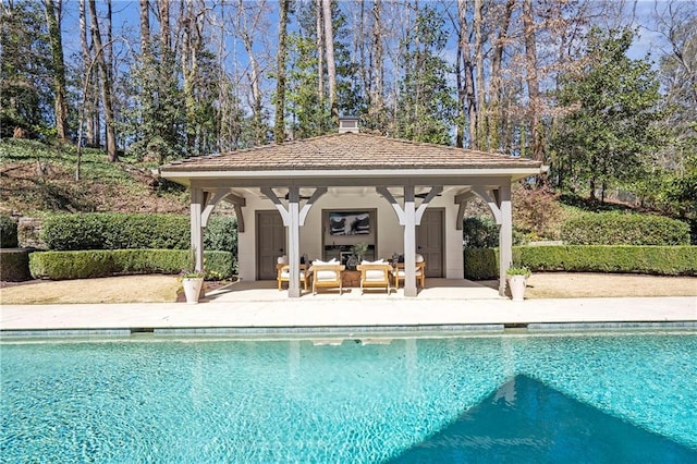 outdoor pool with a gazebo, a patio area, an outdoor structure, an outdoor living space, and a storage structure