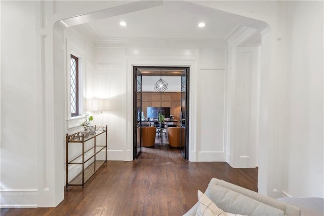 hallway featuring ornamental molding, recessed lighting, and wood finished floors