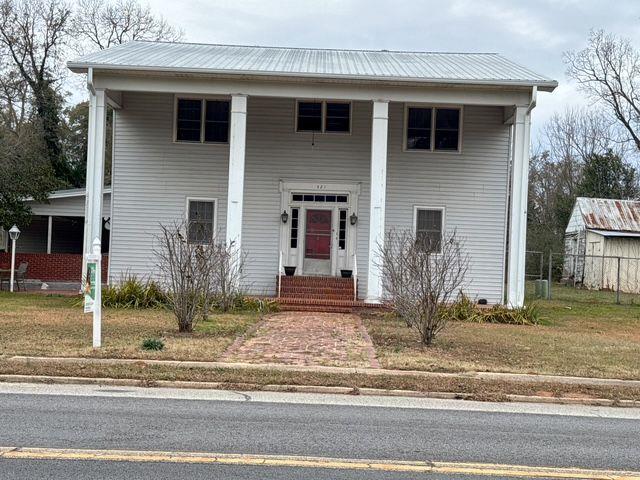 greek revival house featuring a front lawn