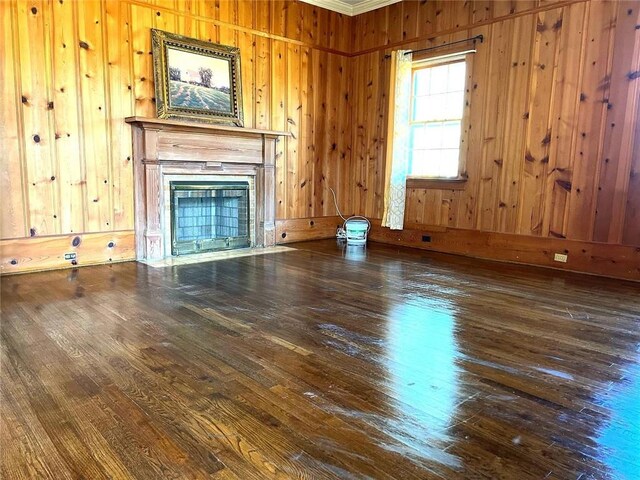 unfurnished living room with hardwood / wood-style flooring and wood walls