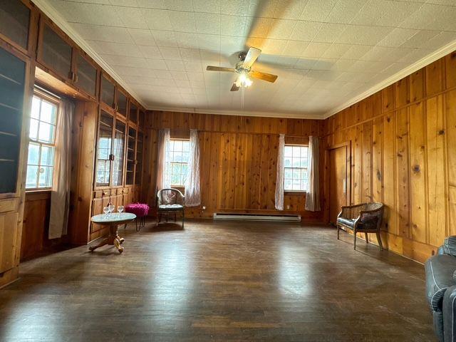 unfurnished room with a wealth of natural light and dark hardwood / wood-style flooring