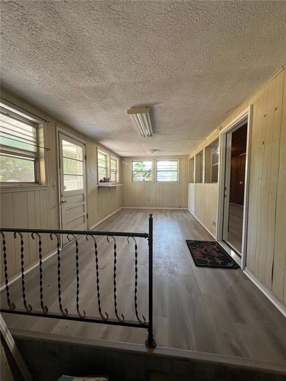 spare room with hardwood / wood-style floors and a textured ceiling