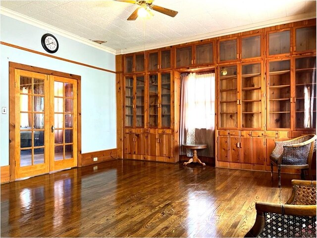 interior space featuring french doors, crown molding, ceiling fan, a textured ceiling, and wood-type flooring