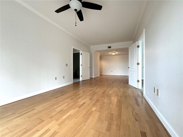 empty room with ceiling fan, crown molding, and light hardwood / wood-style flooring