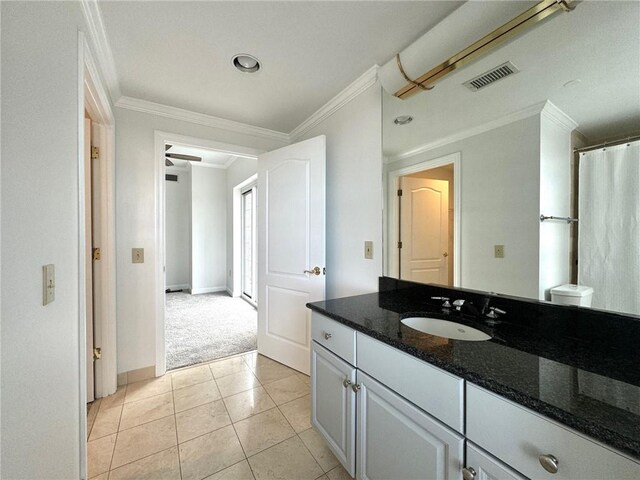 bathroom with tile patterned floors, vanity, ceiling fan, and crown molding