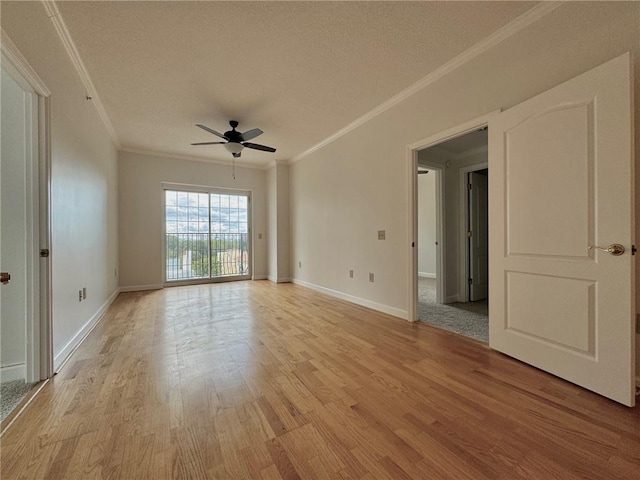 unfurnished room with light hardwood / wood-style flooring, ceiling fan, and crown molding