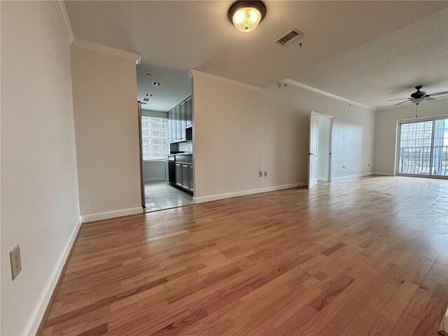 unfurnished living room with light hardwood / wood-style flooring, ceiling fan, and ornamental molding