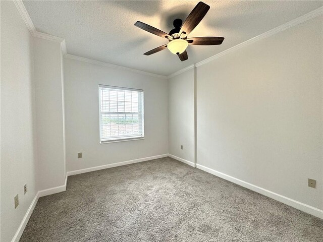 carpeted spare room featuring a textured ceiling, ceiling fan, and crown molding